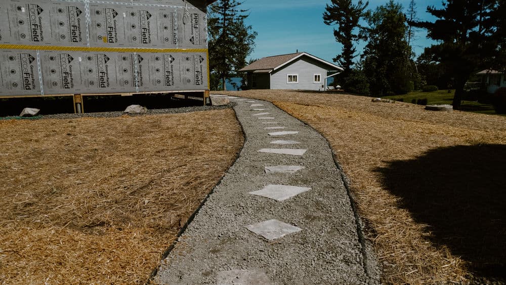 Full Landscaping Overhaul with Boulder Walls and Gravel Driveway in Luck, WI